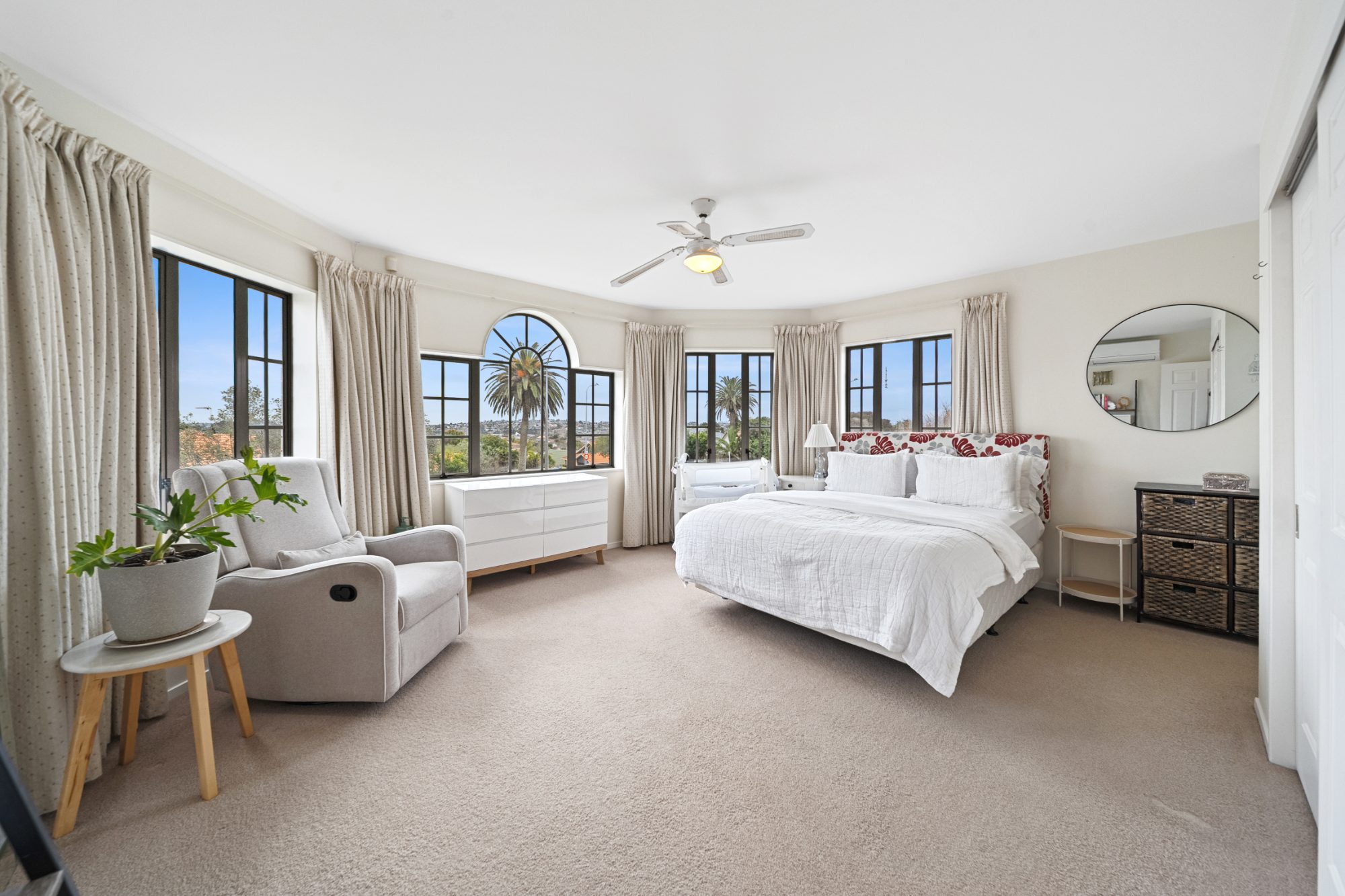 Master bedroom with bay windows and sitting area in a Dannemora home