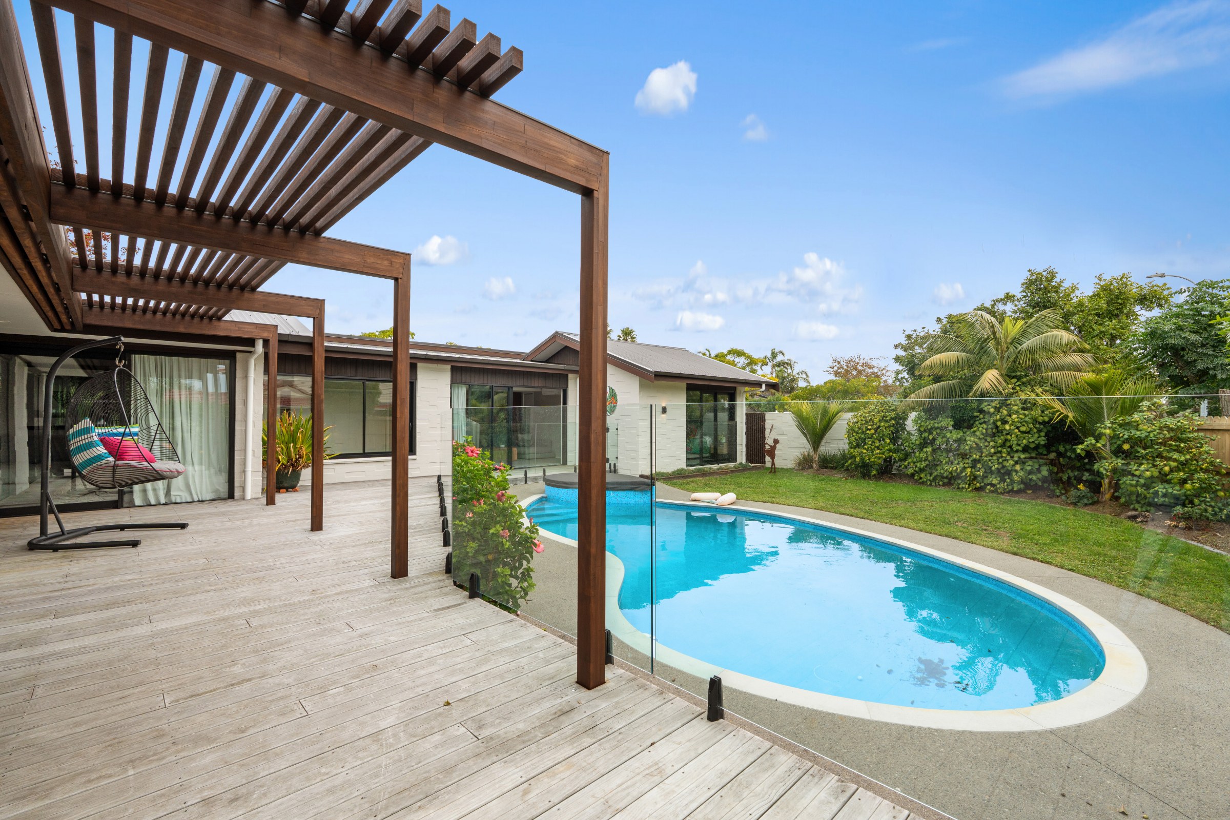 Pool and pergola beside a single-level home in Howick