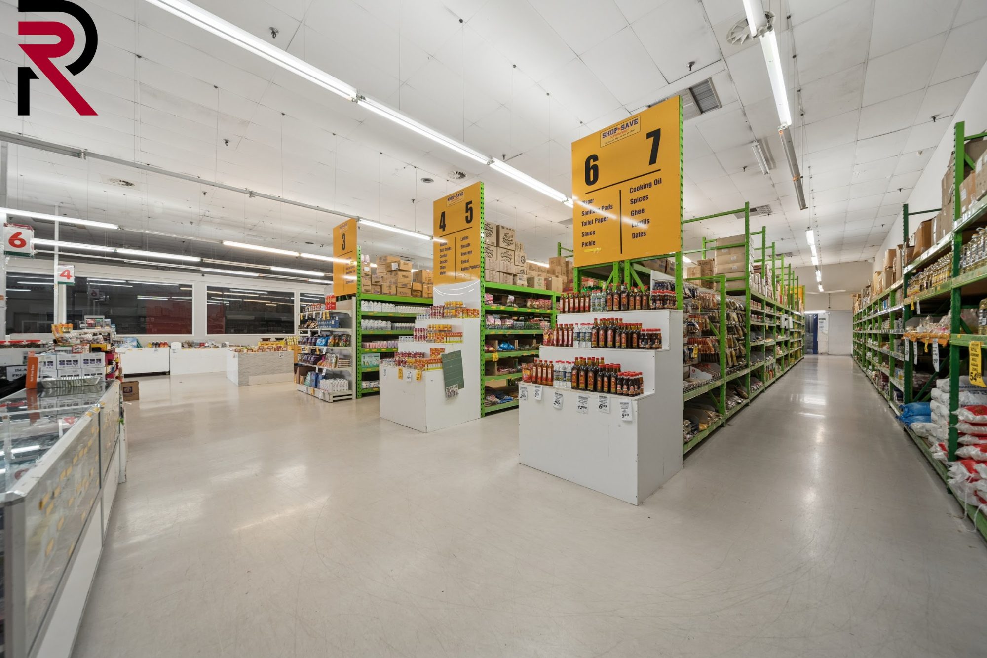 Supermarket aisles with shelving and signage in Māngere