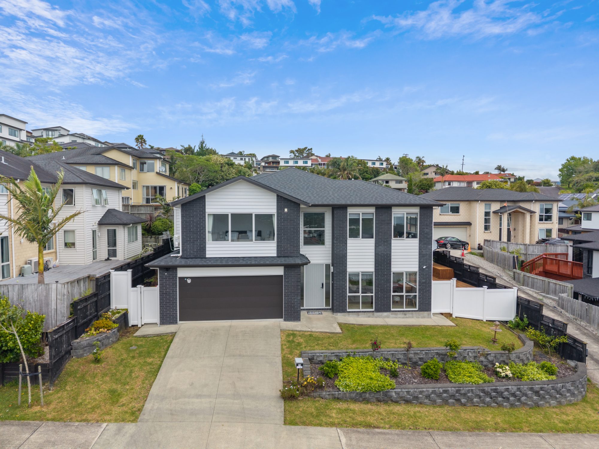 Aerial photo of a two-storey home with dark cladding in Ranui