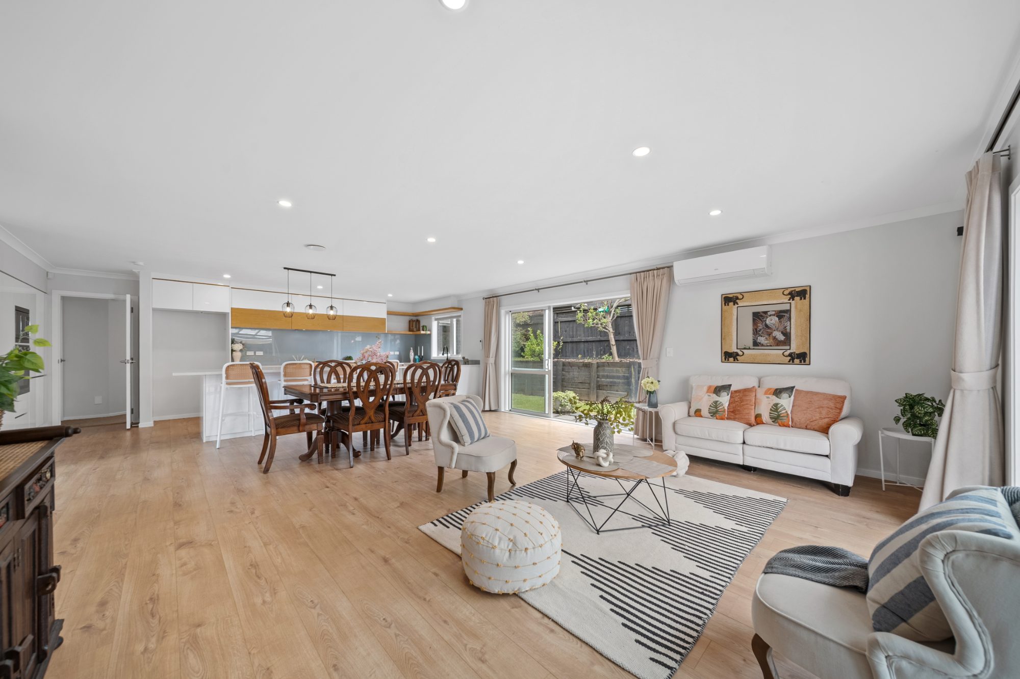 Open-plan dining and living area in a Ranui home