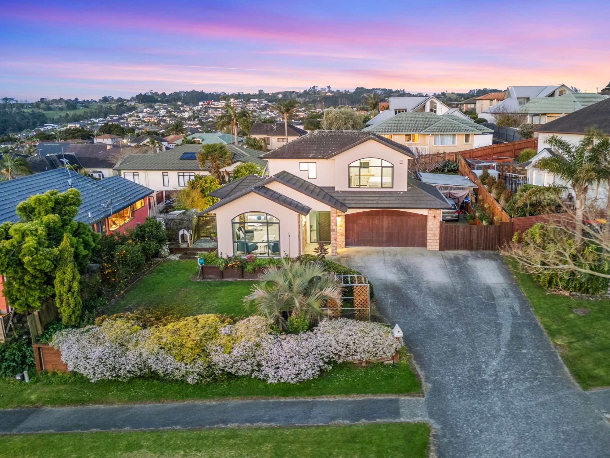 Twilight drone photo of a home and front garden in The Gardens, Manukau